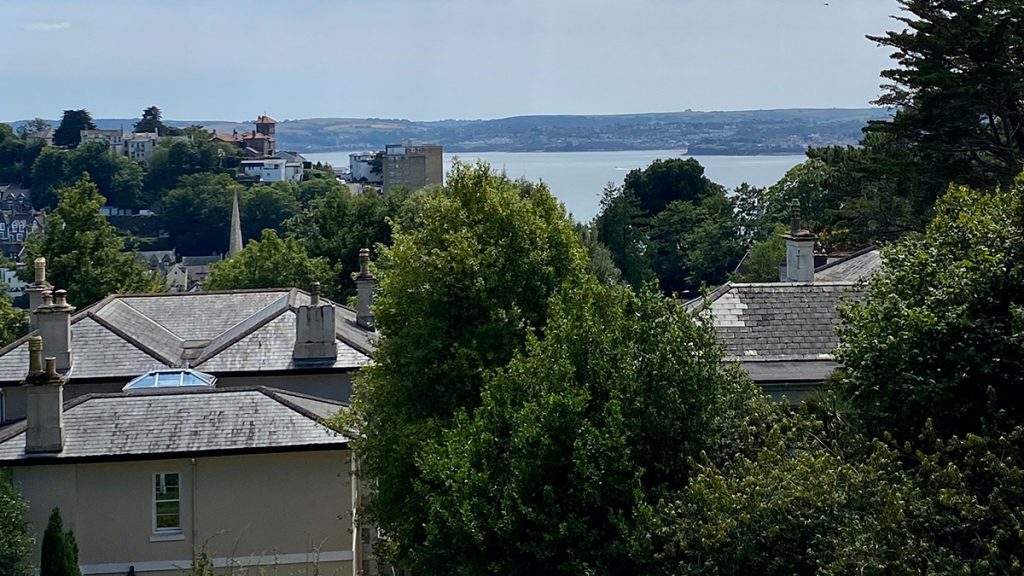 Balcony overlooking the garden and sea views at Vomero Holiday Apartments in Torquay